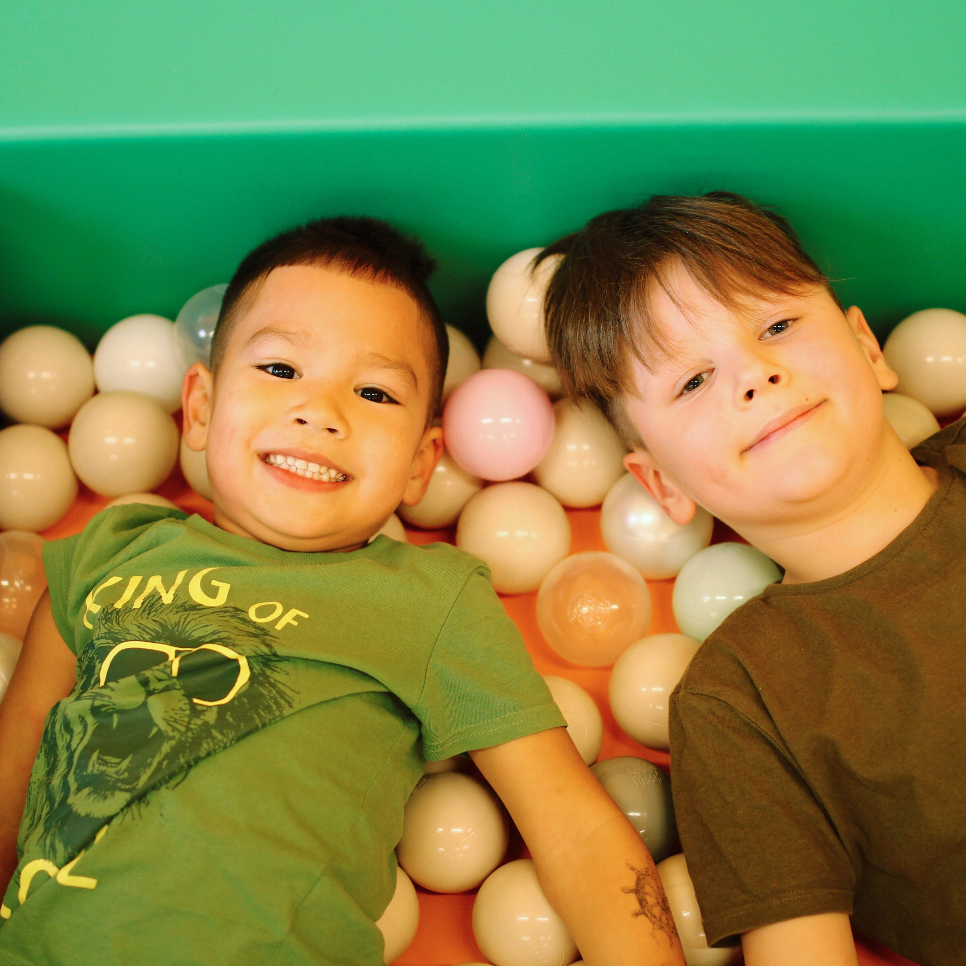 Children playing in a colourful soft play area